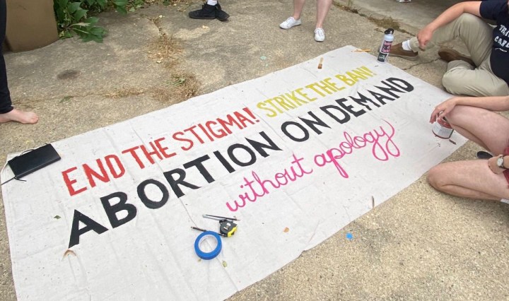 A banner that reads End the Stigma! Strike the ban! Abortion on Demand Without Apology